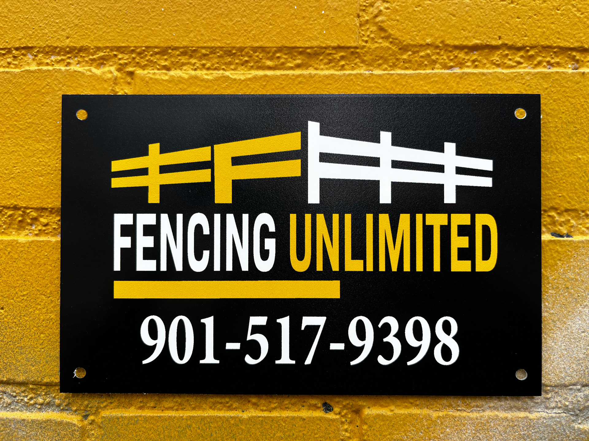Black custom fence sign for Fencing Unlimited with yellow and white fence-rail logo and phone number 901-517-9398